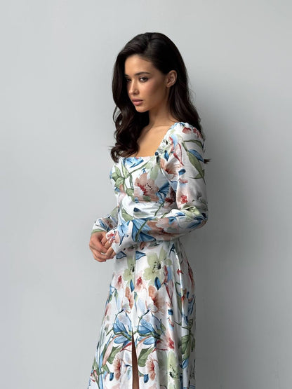 Woman wearing a floral dress against a plain background