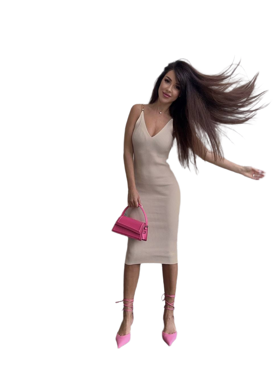 Woman in a beige dress with long hair and pink shoes on a white background