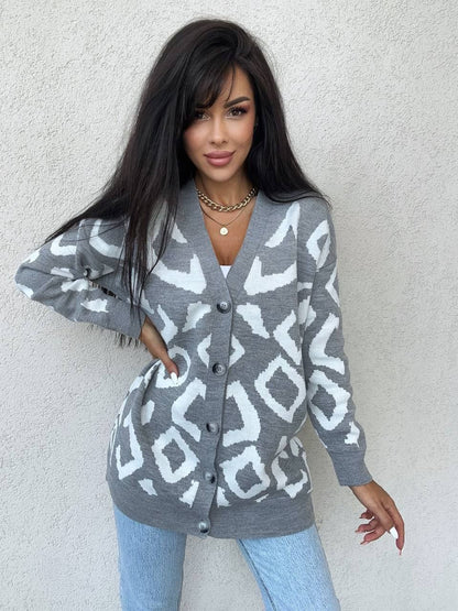 Woman wearing a gray cardigan with white geometric pattern against a light background