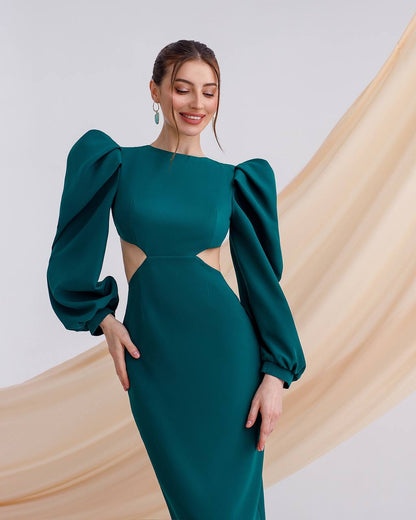 Woman wearing a green dress with puff sleeves against a beige and white background