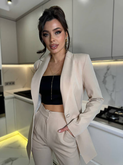 Woman in a beige suit standing in a modern kitchen