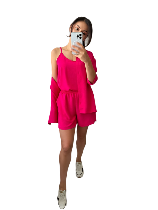 Person wearing a bright pink outfit on a white background
