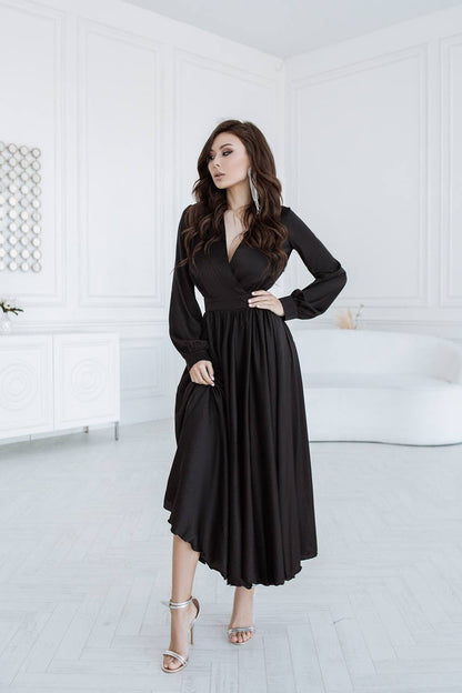 Woman wearing a black dress in a white room