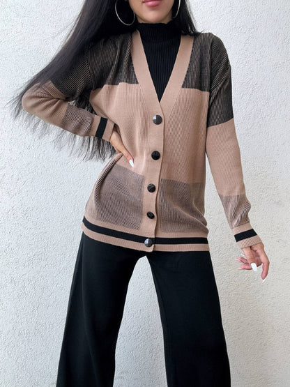 Person wearing a beige cardigan with black buttons against a white background