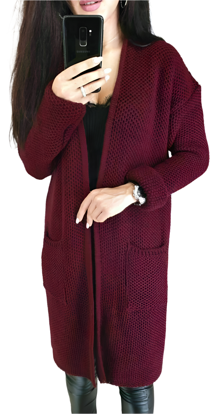 Person wearing a burgundy knitted cardigan on a white background