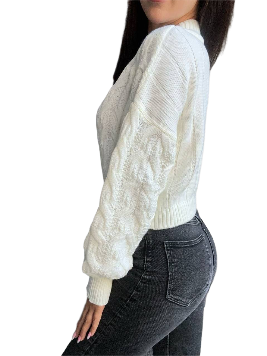 White cable knit sweater with lace sleeves worn by a person on a white background