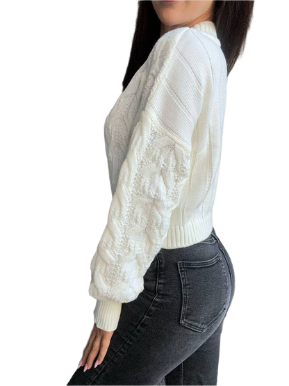 White cable knit sweater with lace sleeves worn by a person on a white background