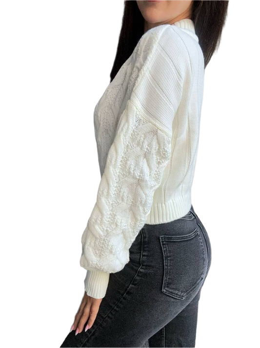 White cable knit sweater with lace sleeves worn by a person on a white background