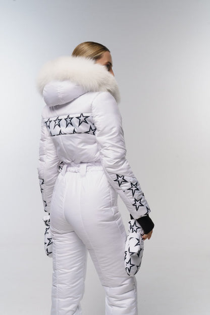 Person wearing a white winter outfit with star patterns on a plain background