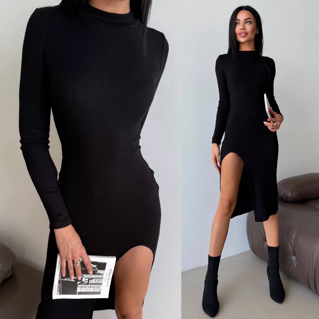 Black ribbed dress with long sleeves and a slit on a plain background
