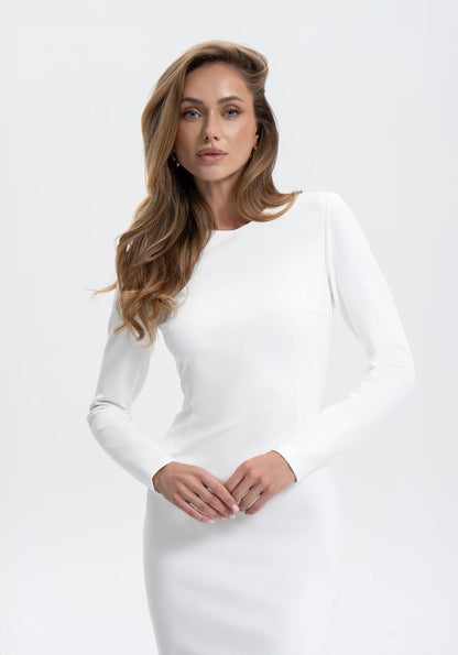 Woman wearing a white dress against a plain background