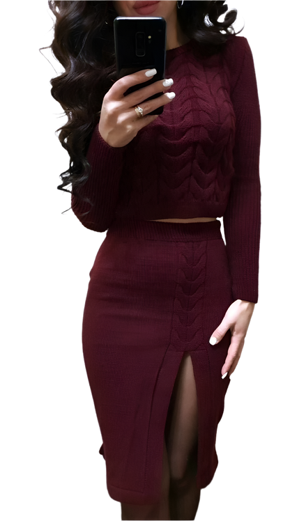 Person wearing a burgundy long-sleeve top and skirt set, holding a phone.