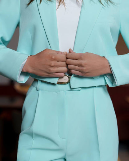 Person wearing a light blue suit with a blurred background