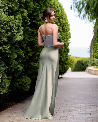 Woman in a two-tone dress standing in a garden setting