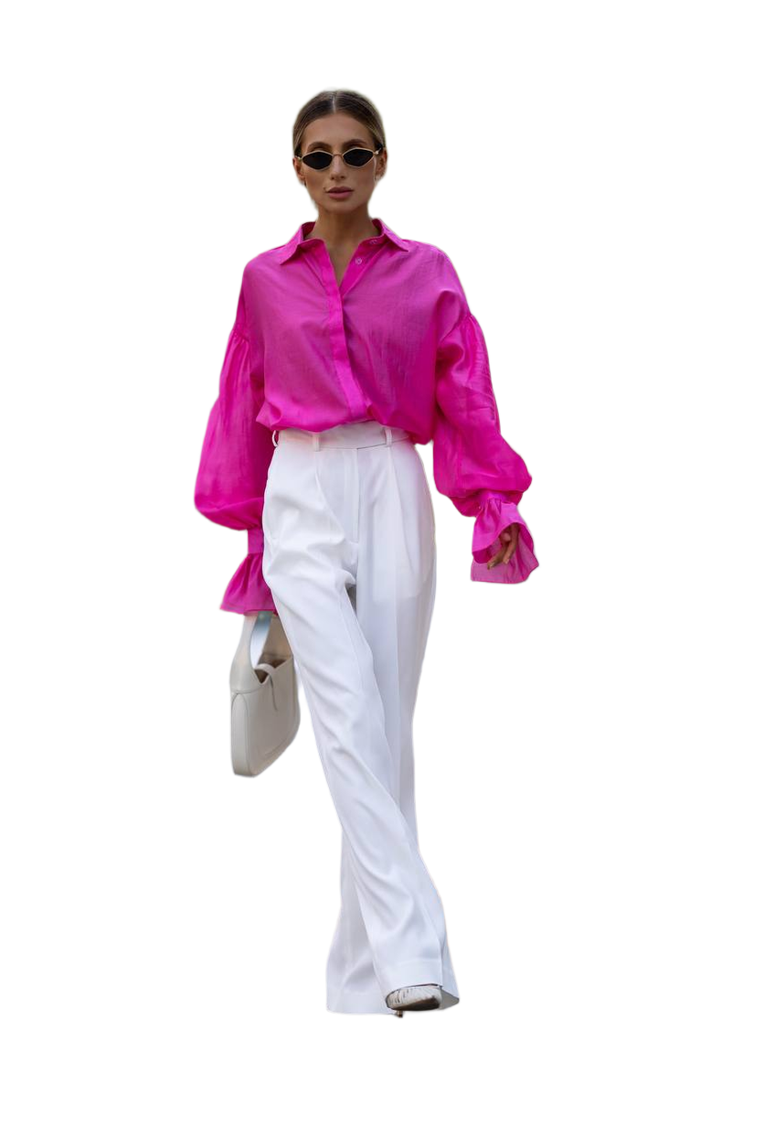 Woman wearing a bright pink shirt and white pants on a white background