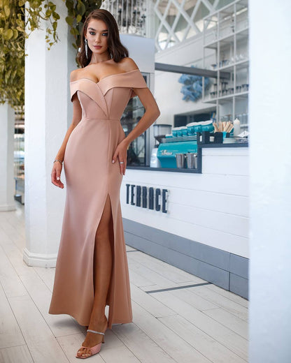 Woman in a beige off-shoulder gown standing in a modern indoor setting with 'TERRACE' branding.