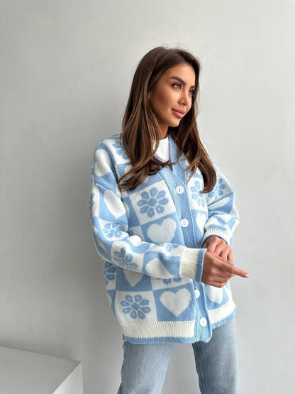 Woman wearing a blue and white patterned sweater against a plain background