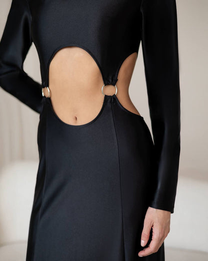 Black dress with cut-out back design on a neutral background