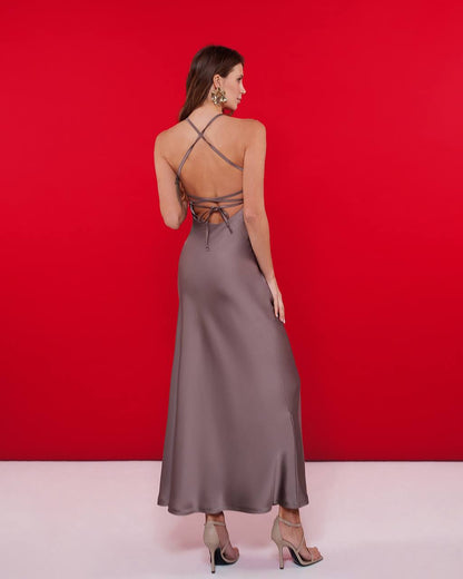 Woman wearing a backless dress with a red background