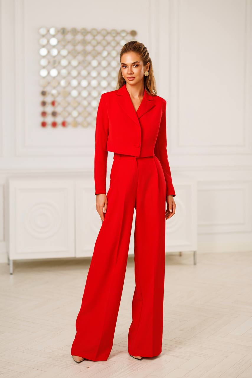 Woman wearing a red outfit in a minimalistic room