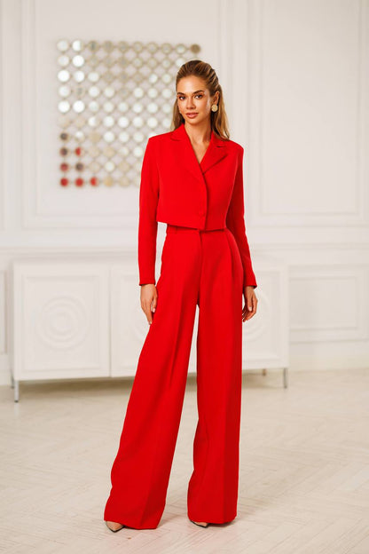Woman wearing a red outfit in a minimalistic room