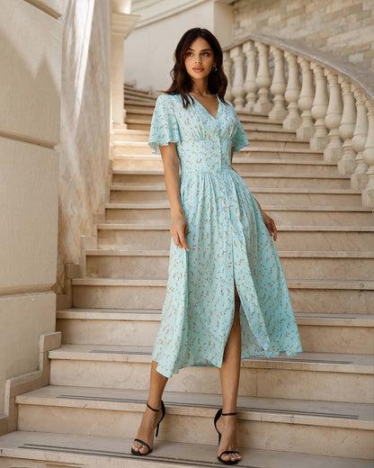 Woman in a light blue dress standing on stone steps