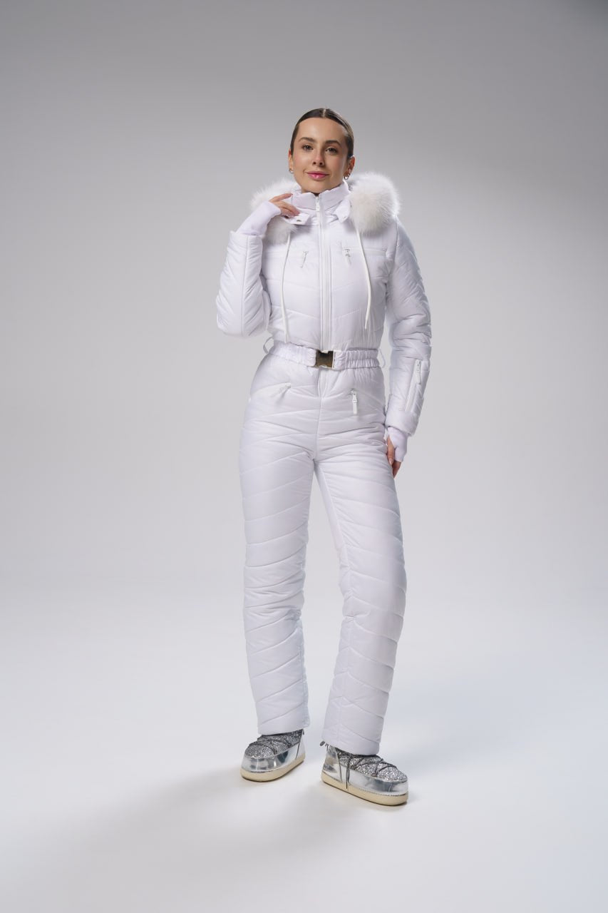 Person wearing a white puffer suit with fur-lined hood on a gray background