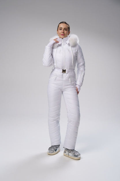 Person wearing a white puffer suit with fur-lined hood on a gray background