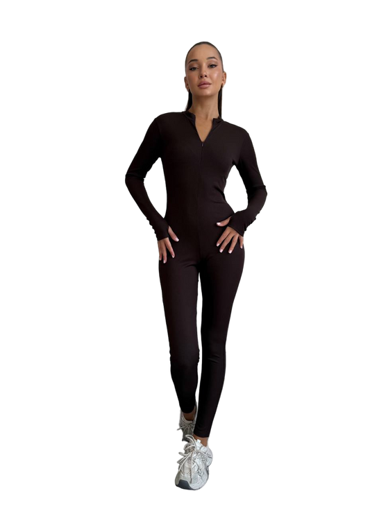 Woman wearing a black long-sleeve top and leggings on a white background
