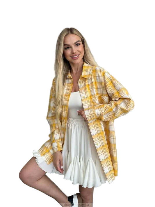 Woman wearing a yellow plaid shirt over a white dress on a white background