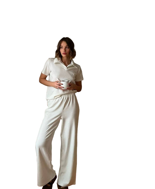 Woman wearing a white outfit holding a cup on a white background
