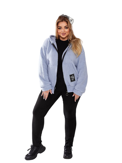Woman wearing a light blue jacket with a brand logo on a white background