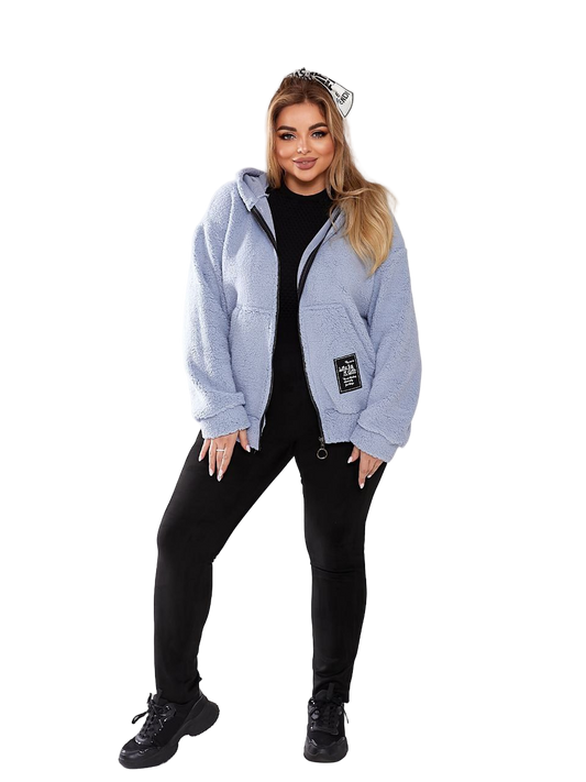 Woman wearing a light blue jacket with a brand logo on a white background