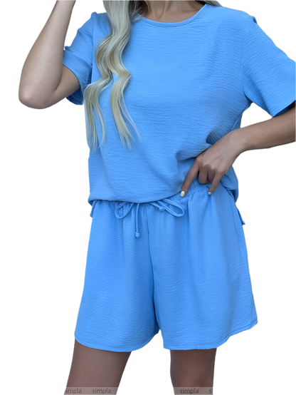 Blue outfit with a top and shorts on a white background