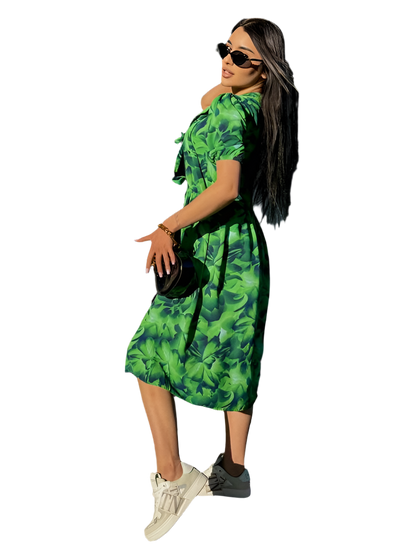 Woman wearing a green floral dress on a white background