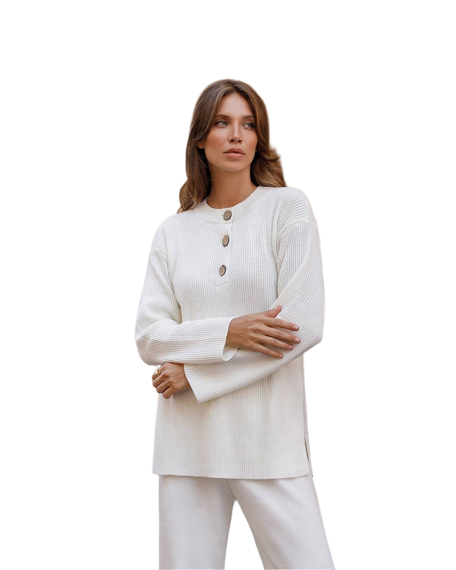 Woman wearing a white ribbed sweater with button details on a white background