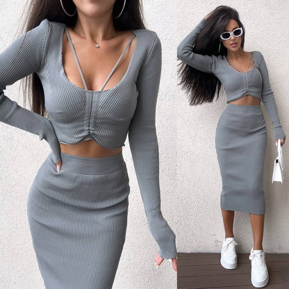 Woman wearing a gray ribbed two-piece outfit with a white background