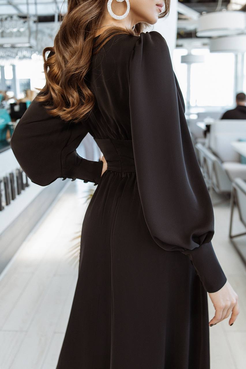 Woman wearing a black dress in an indoor setting