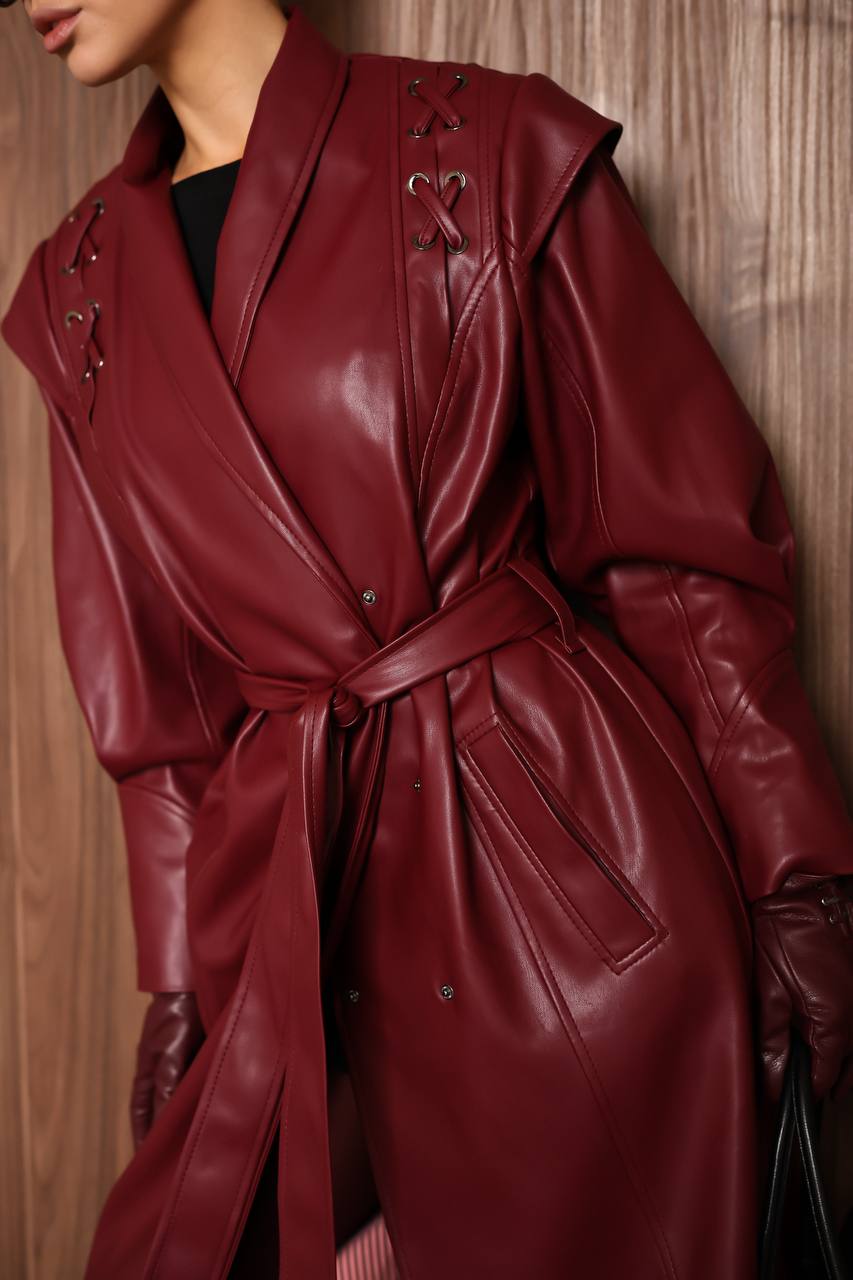 Red leather coat worn by a person against a wooden background