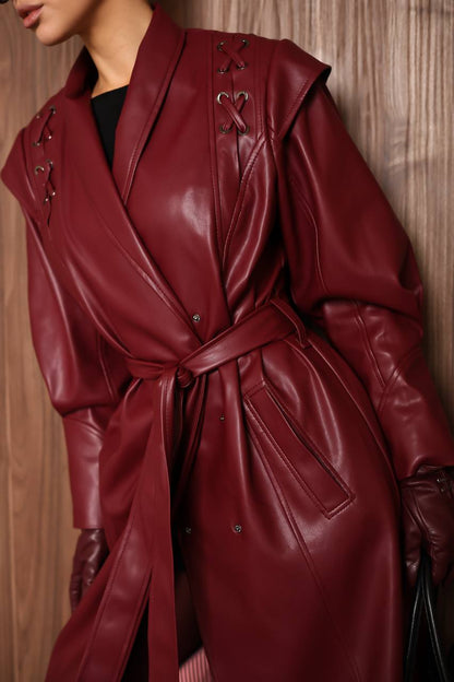 Red leather coat worn by a person against a wooden background