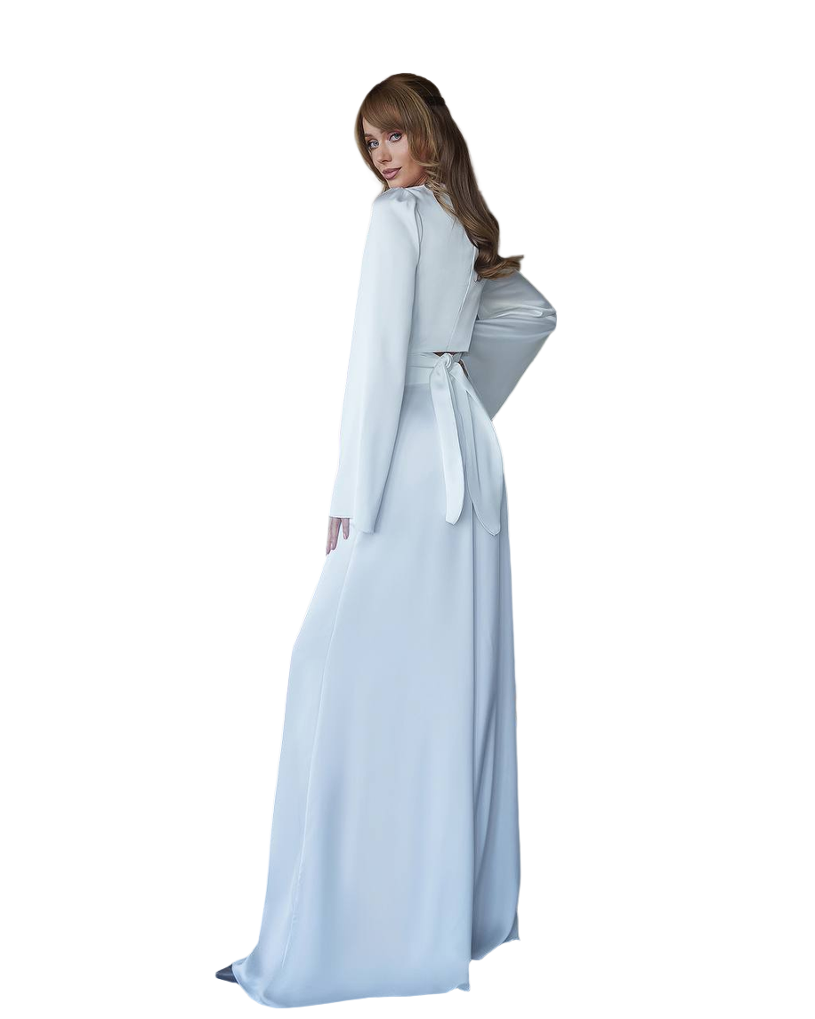 Person wearing a light blue dress with a cape on a white background