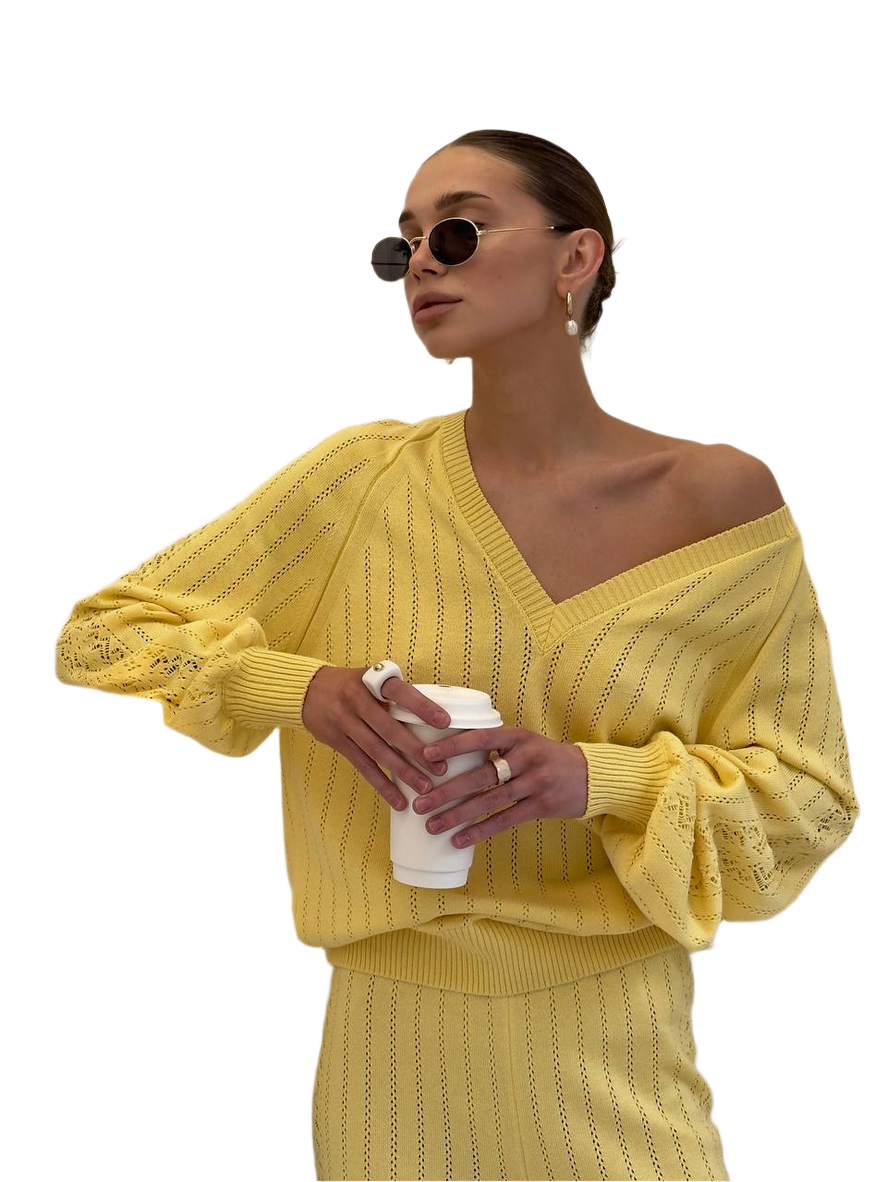 Woman wearing a yellow outfit holding a coffee cup on a white background