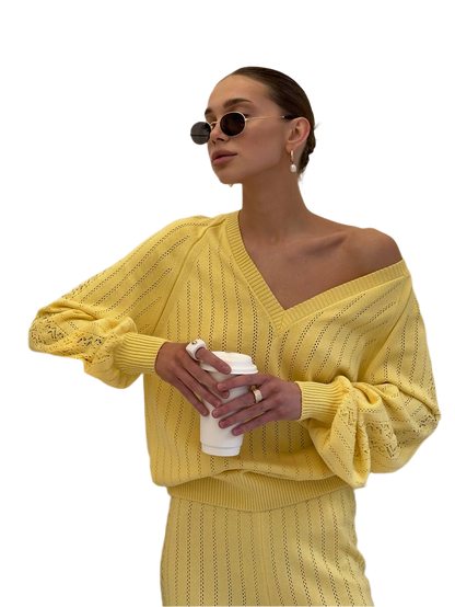 Woman wearing a yellow outfit holding a coffee cup on a white background