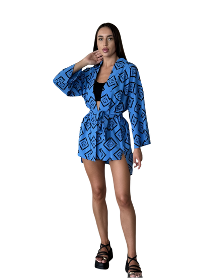Woman wearing a blue patterned kimono-style garment on a white background