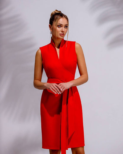 Woman wearing a red dress against a gray background