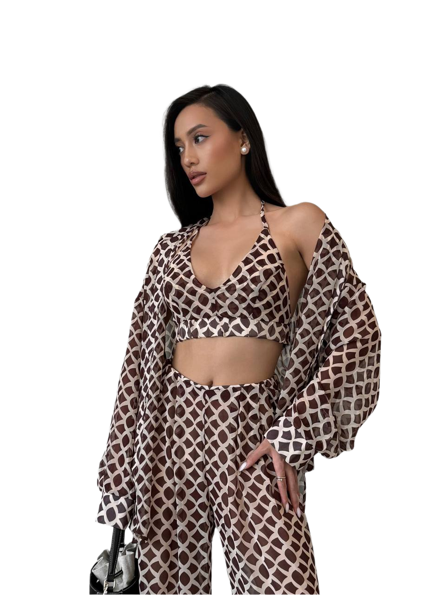 Woman wearing a patterned outfit on a white background