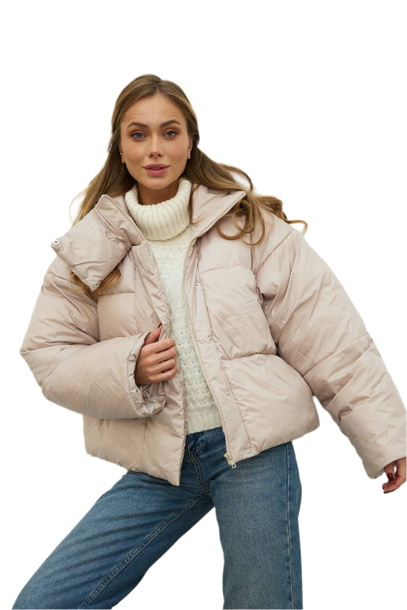 Woman wearing a beige puffer jacket on a white background