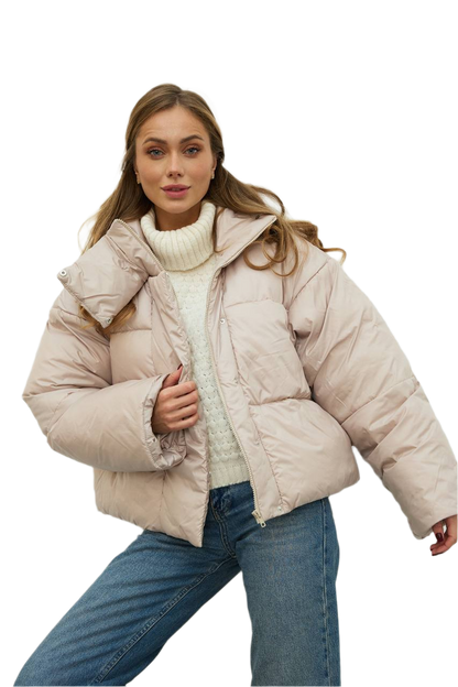 Woman wearing a beige puffer jacket on a white background