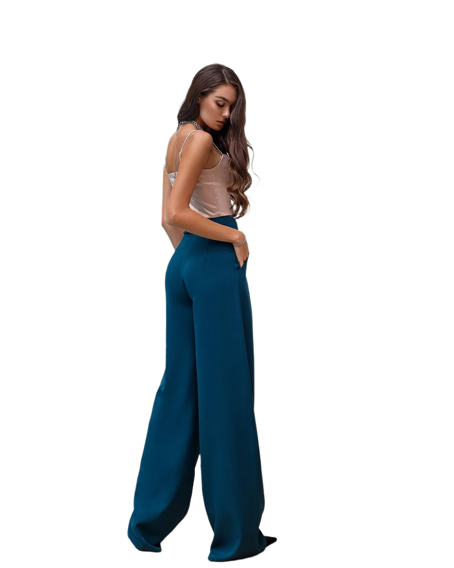Woman wearing teal wide-leg pants on a white background