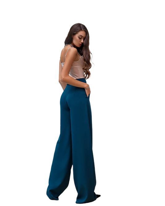 Woman wearing teal wide-leg pants on a white background